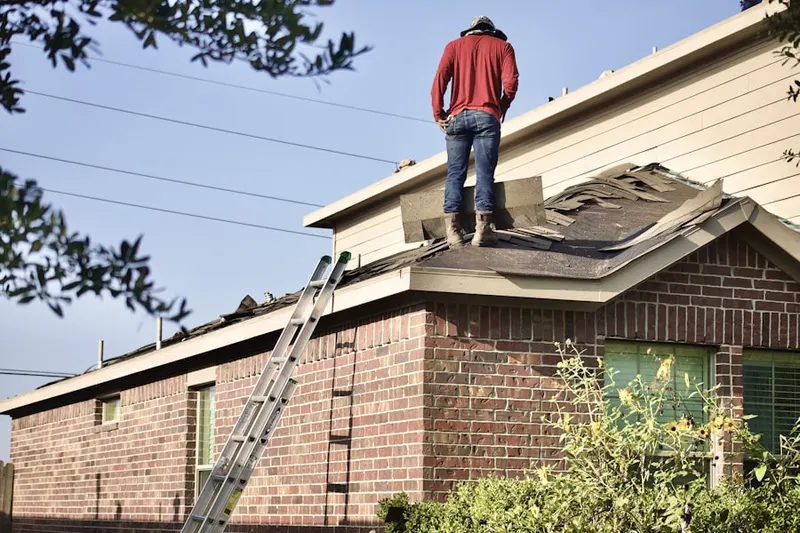 Professional roofer working on a residential roof in Charmingdale